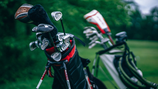 two sets of golf clubs and bags