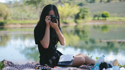 girl taking a photograph with her camera