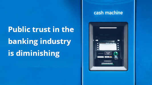 Bank cash machine and words public trust in banks is diminished