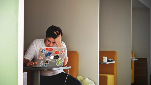 man at laptop stressing