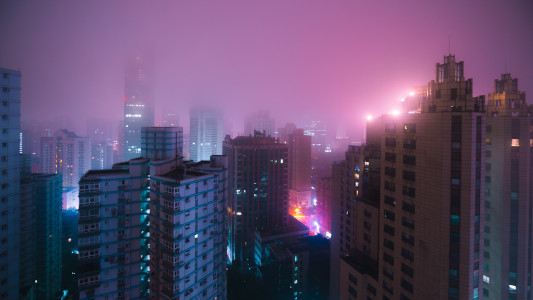 Late night foggy city with skyscrapers
