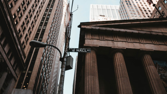 wall street sign next to bank
