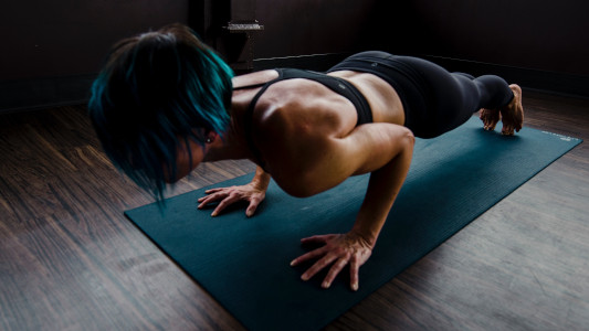 woman doing pushups on a mat