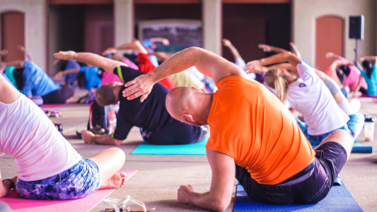 people sitting stretching in yoga class